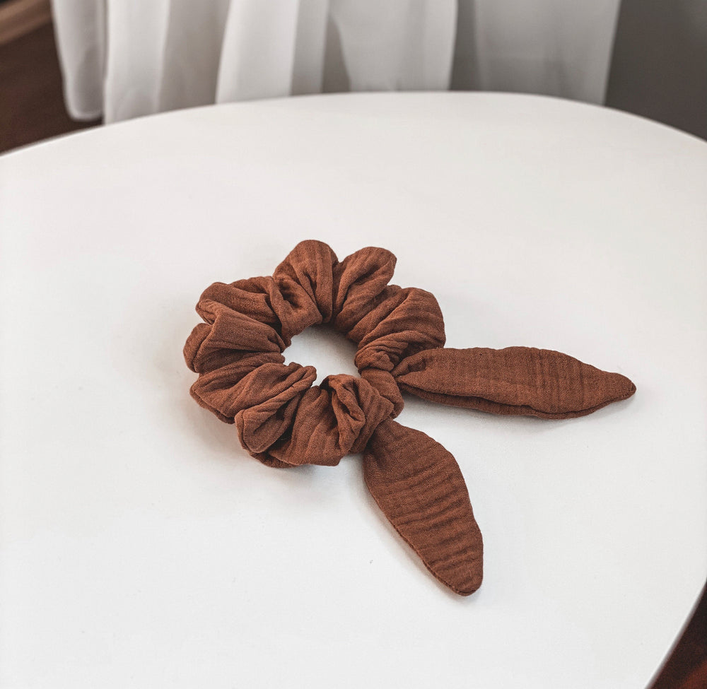 amelia rose the label canadian designer soft cotton oversize scrunchie with cute bunny tails flat lay on a white table in brown