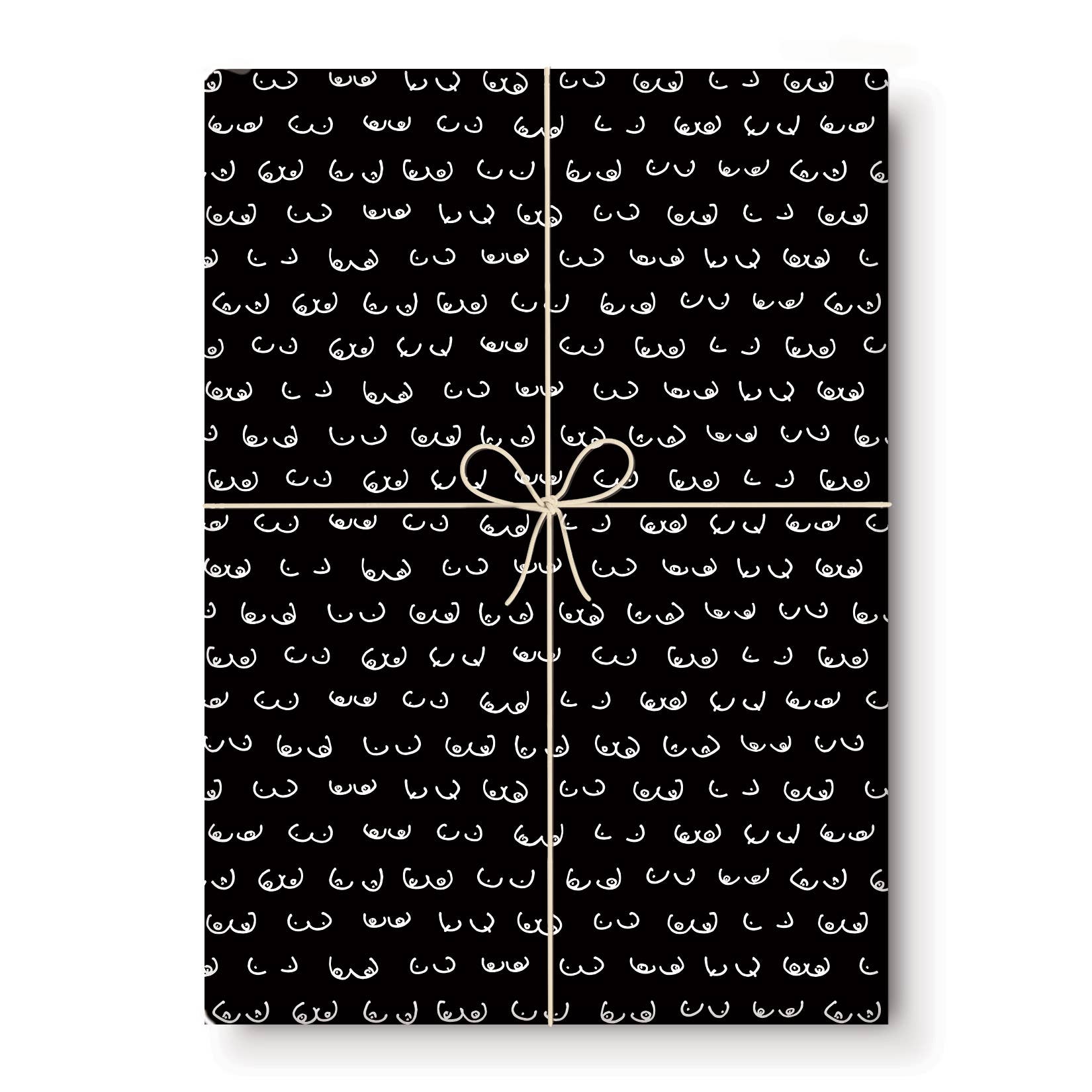 Sheet of black gift wrap with boob print