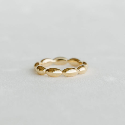 Gold bubble ring on a light gray background