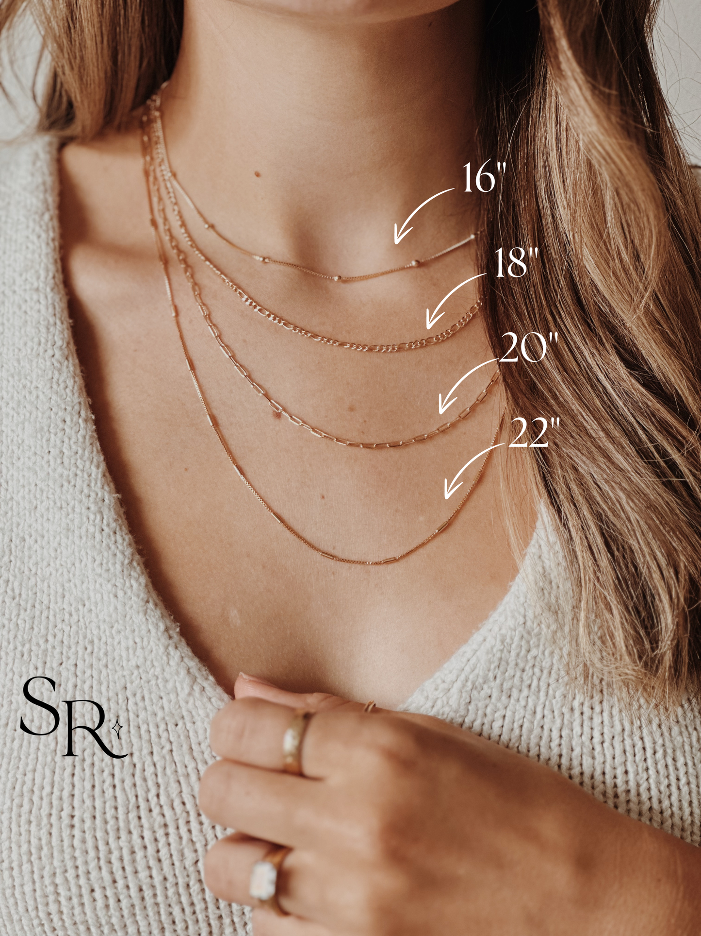 Necklace display with measurements on a person wearing a light-colored sweater.