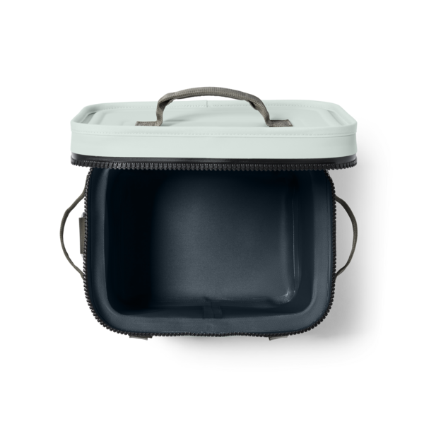 YETI hopper 12 insulated cooler bag in ridgeline green color shown from a top-down view, with a light mint green exterior, dark navy interior, black zipper, and gray handle on a white background.