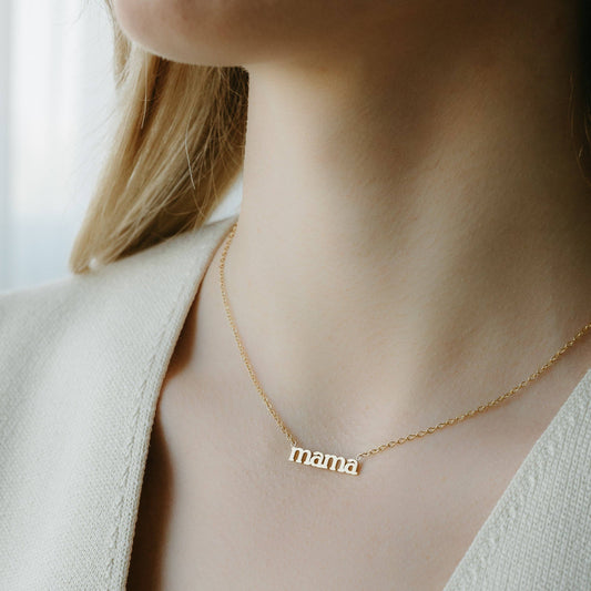 Close-up of gold mama necklace pendant – minimalist gift for mom