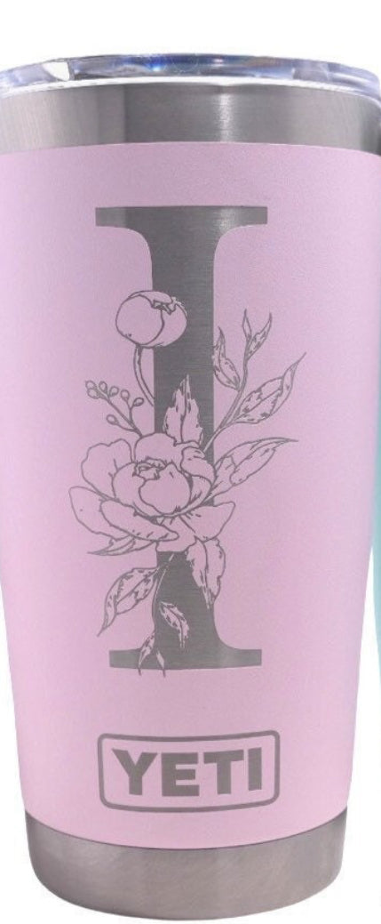 Custom engraved pink YETI tumbler featuring a floral script initial design on the matte logo side
