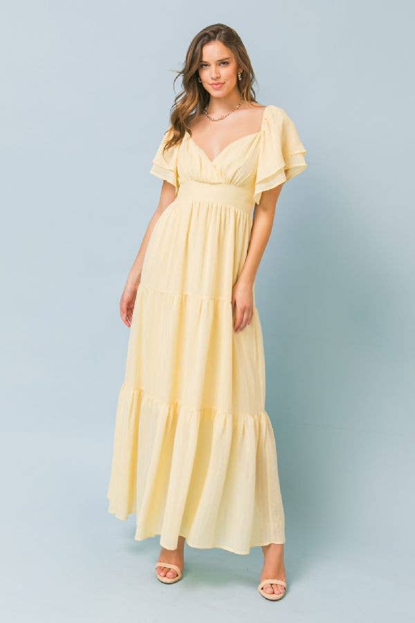 A solid woven maxi dress featuring surplice neckline, double layer flutter sleeve, tiered skirt, surplice back and smocked back waist band. Details Self: 52% Rayon 48% Polyester Lining: 100% Polyester Size & Fit - Model is 5`8" And Wearing Size Small - Measurements Taken From Size Small - Approx. Length: 47"