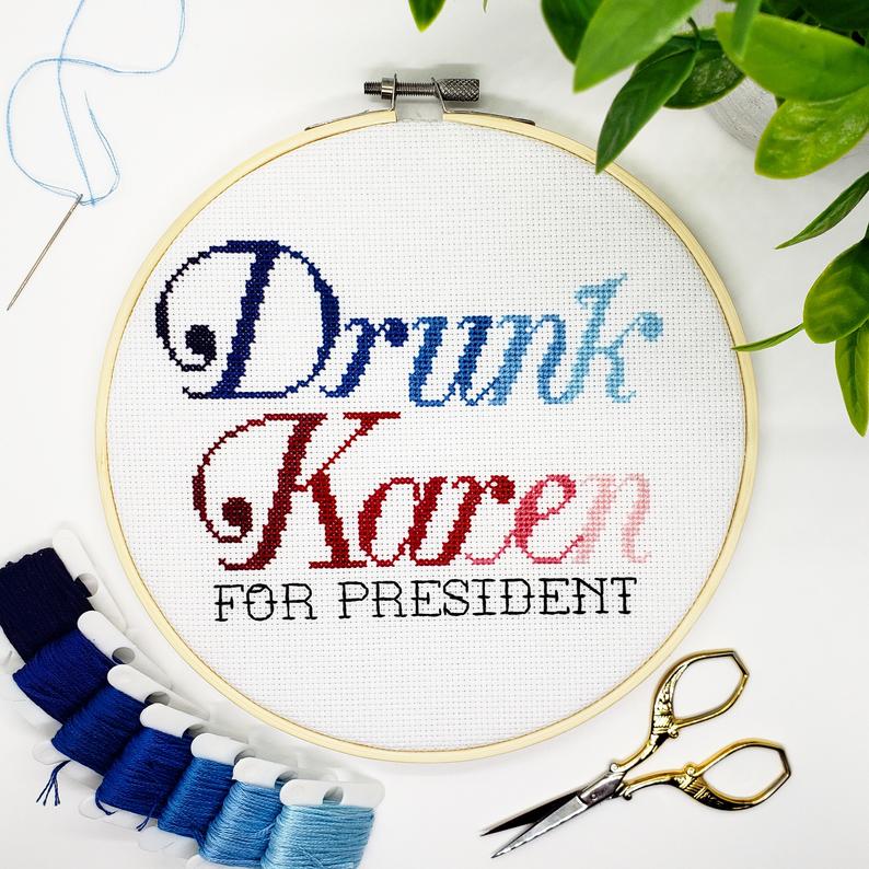 Embroidery hoop with 'Drunk Karen For President' text, surrounded by embroidery threads and scissors on a white background.