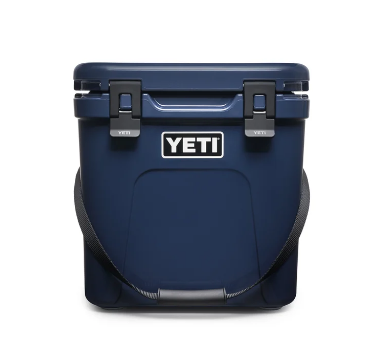 YETI Roadie 24 hard cooler with two heavy duty latches on lid and a shoulder strap in navy