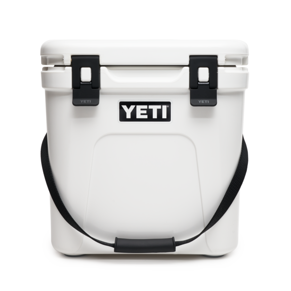 YETI Roadie 24 hard cooler with two heavy duty latches on lid and a shoulder strap in white