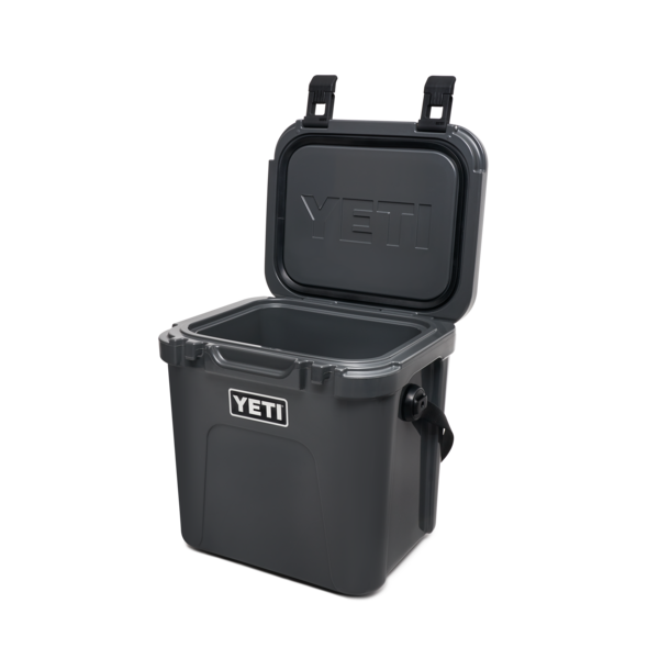 YETI Roadie 24 hard cooler with two heavy duty latches on lid and a shoulder strap in charcoal