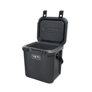 YETI Roadie 24 hard cooler with two heavy duty latches on lid and a shoulder strap in charcoal